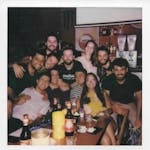 A lively group of friends enjoying a night out in Campinas, Brazil, sharing drinks and laughter.